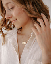 Gold Heavenly Hearts Necklace styled on a woman