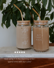 Two glass tumblers with gold straws and engraved text on a wooden surface with a plant in the background.