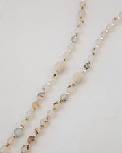 Rosary with multicolor beads and gold accents on a light background