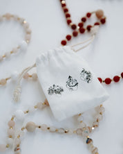 Rosary bag with rosaries on a white background