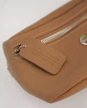 Close-up of a brown leather pouch with a zipper on a white background