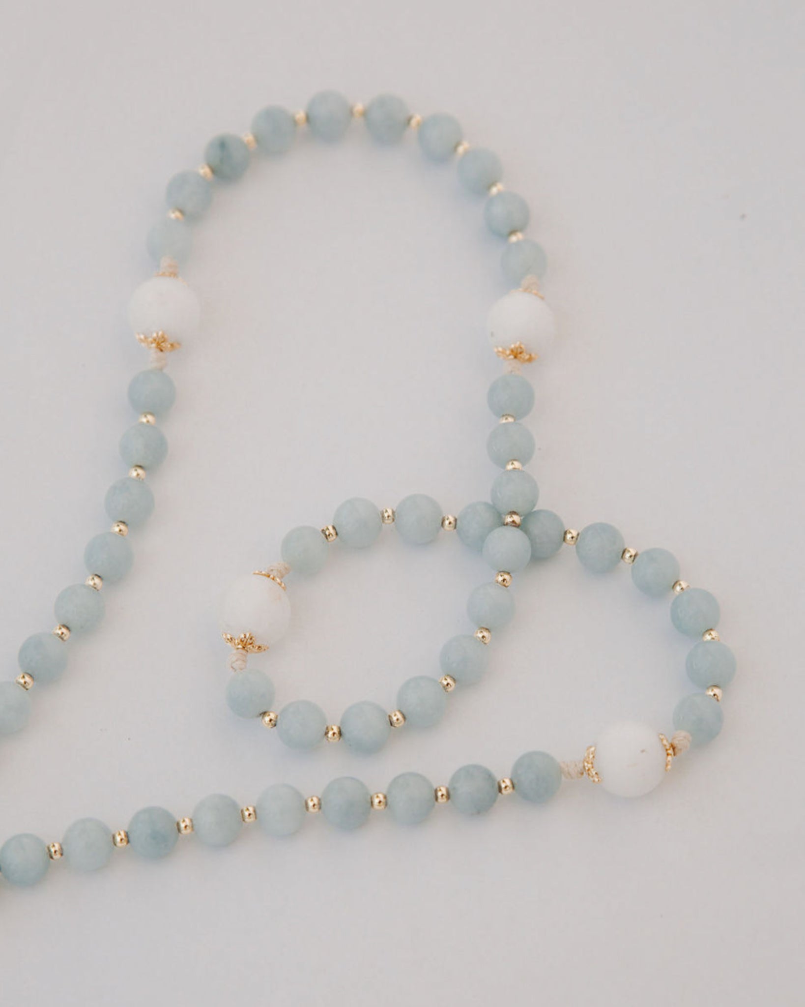 medjugorje rosary bead details on white background