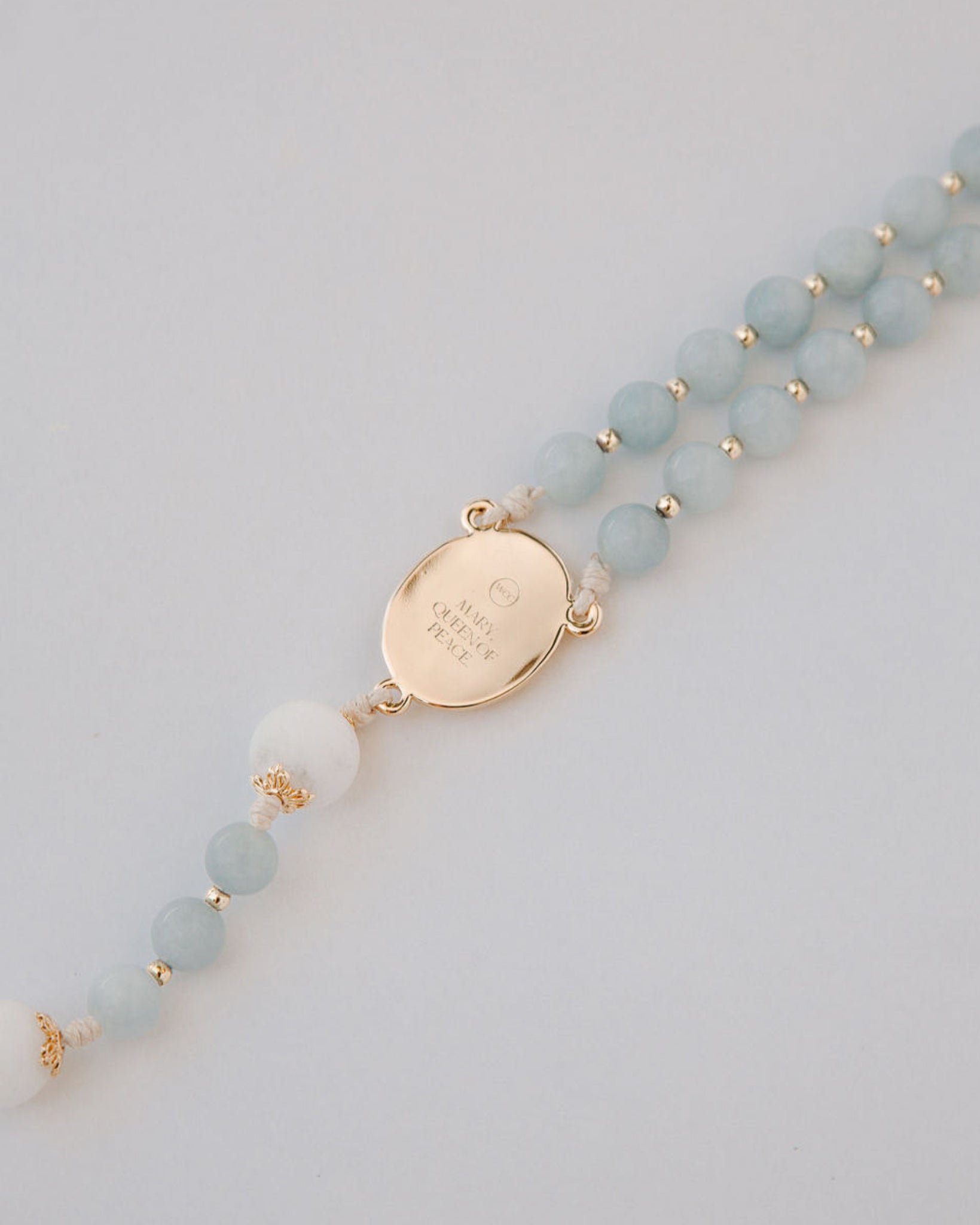 medjugorje rosary gold medal back detail on white background