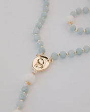 medjugorje rosary gold medal detail on white background