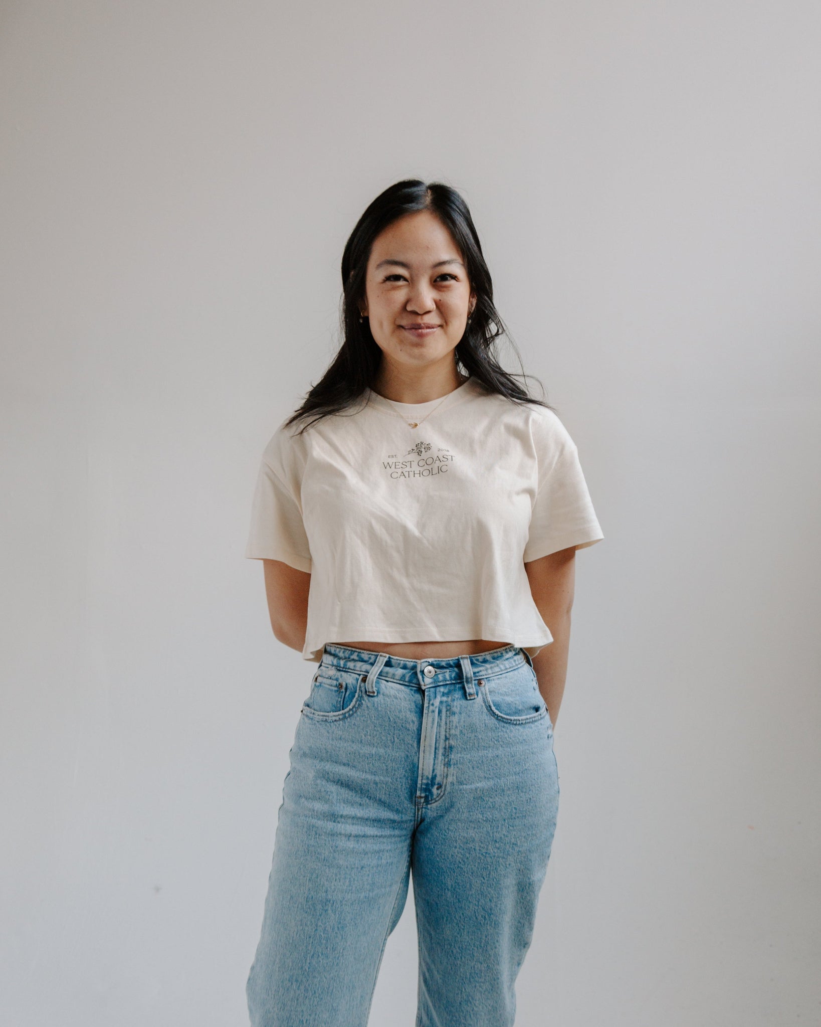 Woman wearing a wcc boxy crew with jeans