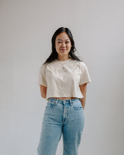 Woman wearing a wcc boxy crew with jeans