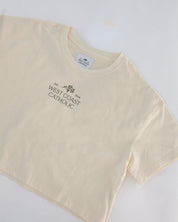 Cream t-shirt with 'West Coast Catholic' text on a white background