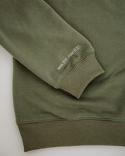 Green crewneck with bible verse embroidered on sleeve