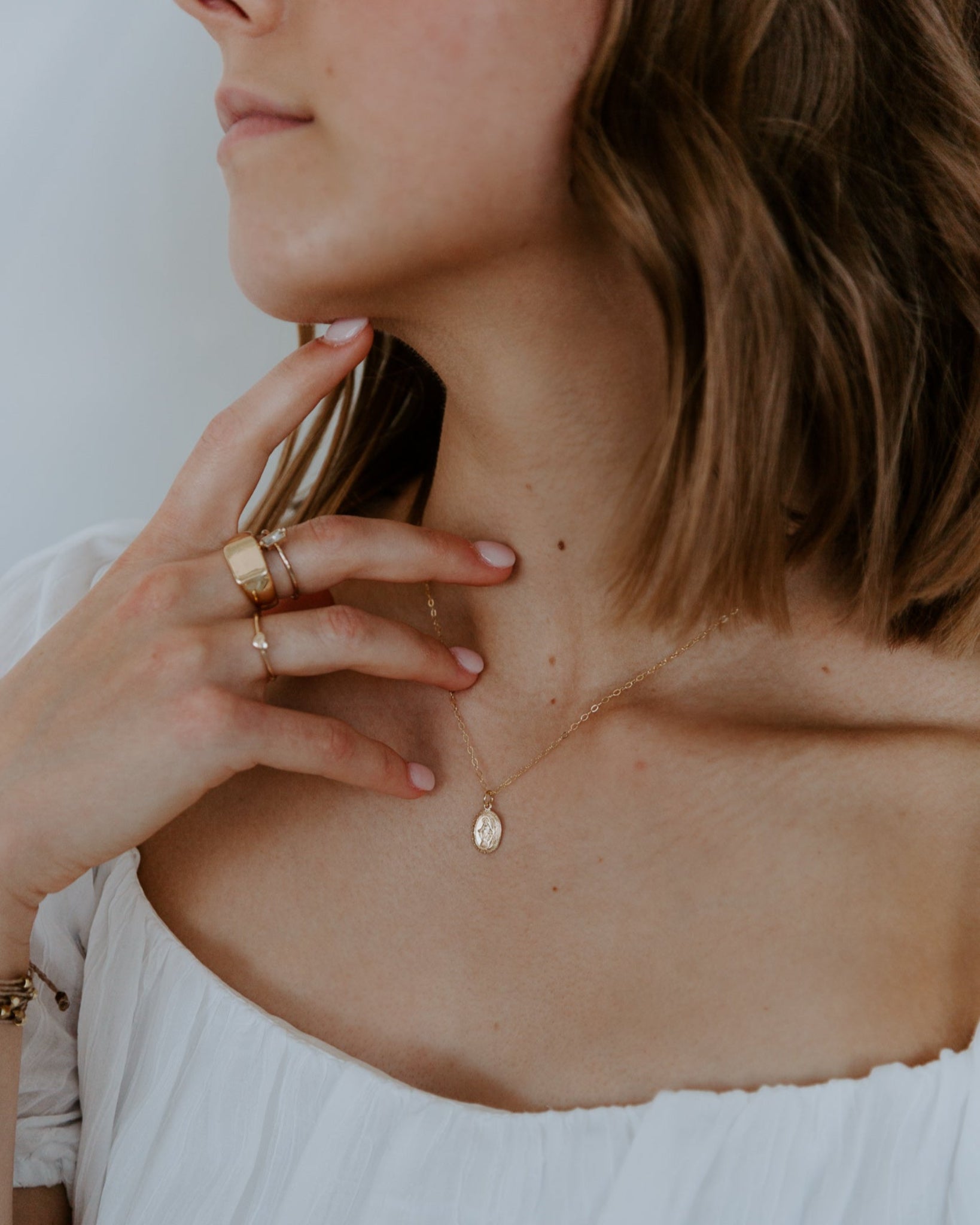 woman wearing a gold miraculous medal