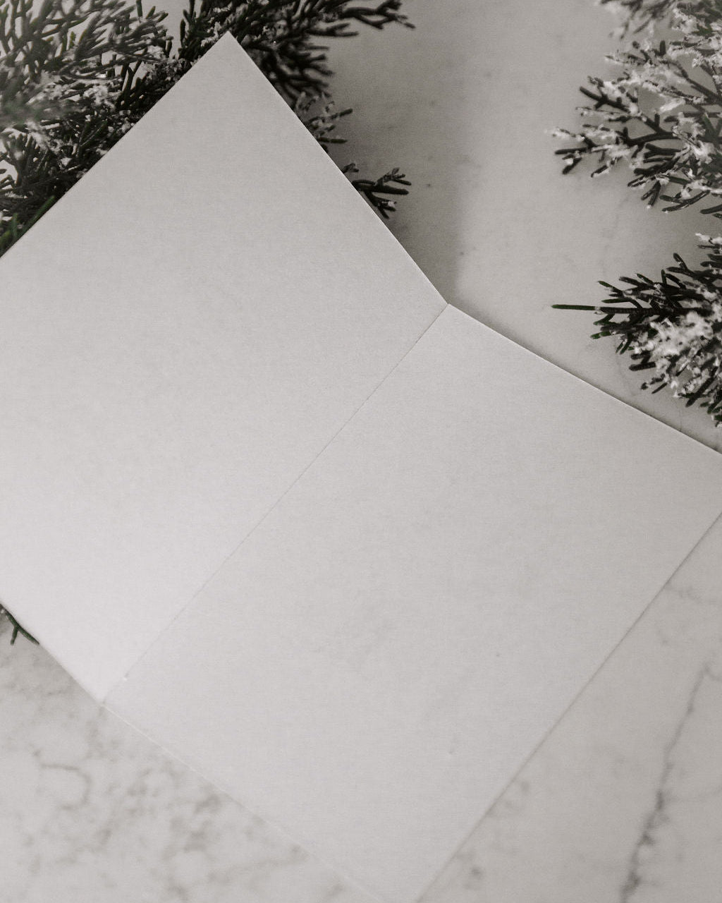 White paper on a marble surface with decorative elements