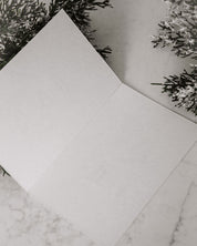 White paper on a marble surface with decorative elements