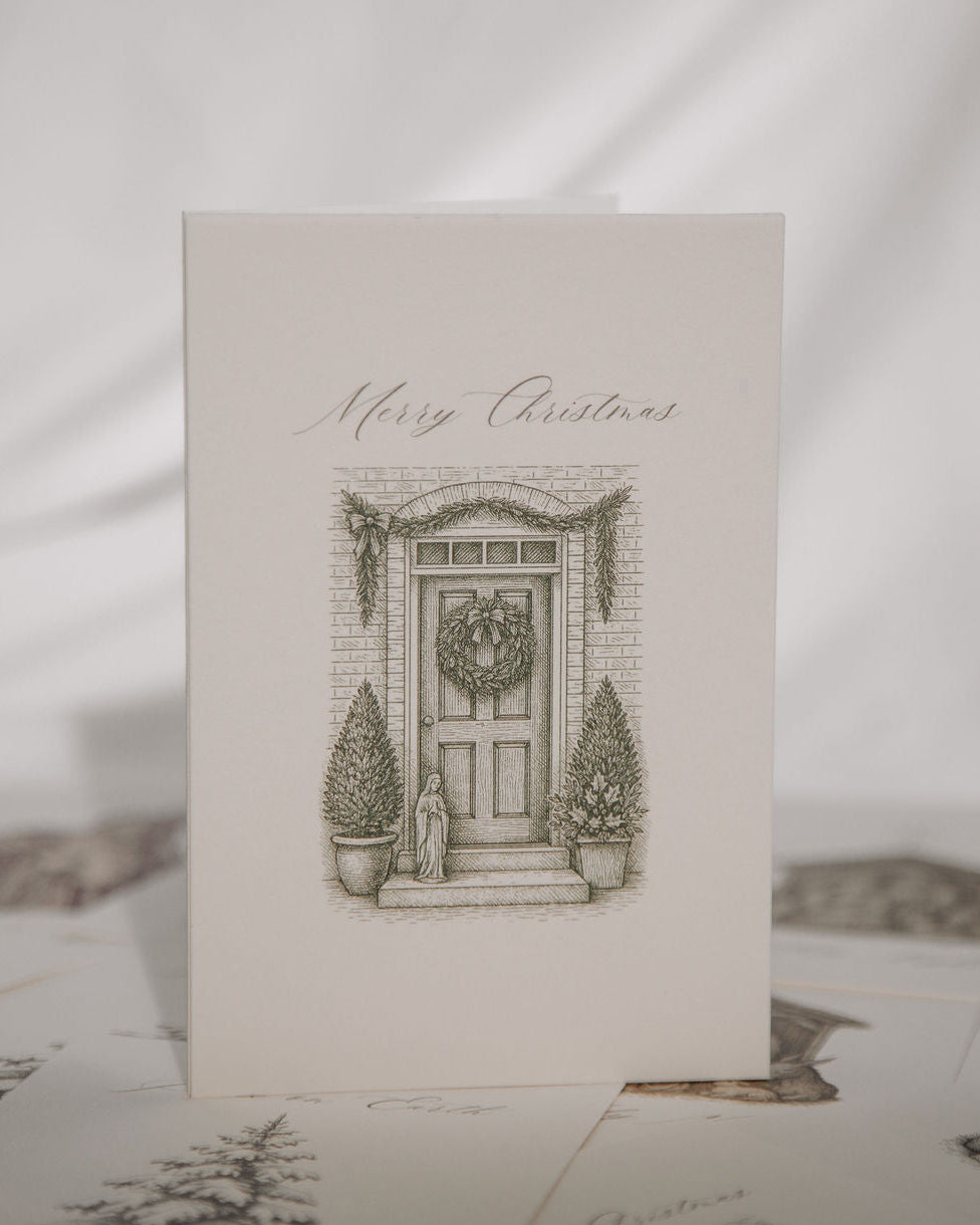 Christmas card with a door and wreath illustration on a white background