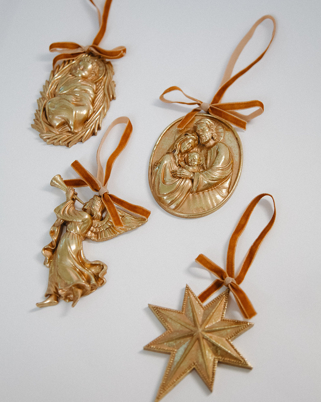 Gold Christmas ornaments with ribbons on a white background