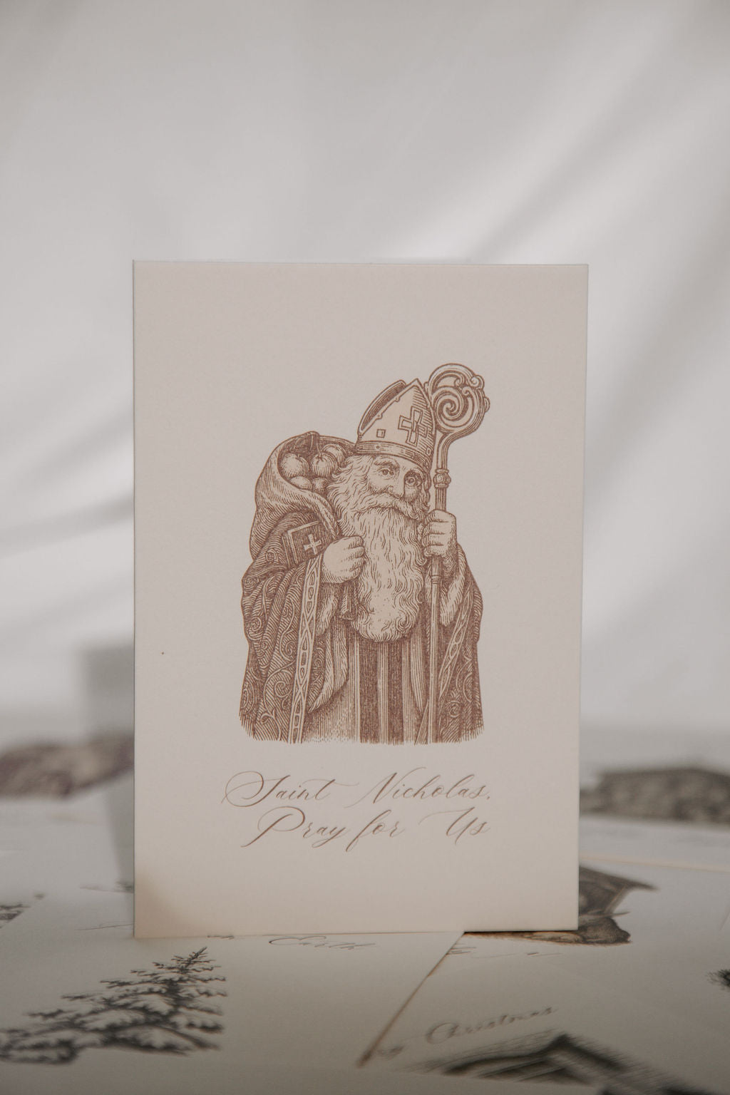 Card with a printed illustration of Saint Nicholas on a textured surface