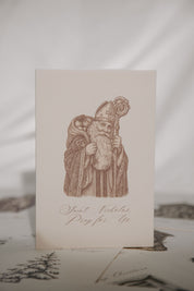 Card with a printed illustration of Saint Nicholas on a textured surface