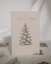 Card with a pine tree illustration and 'Peace on Earth' text on a light background