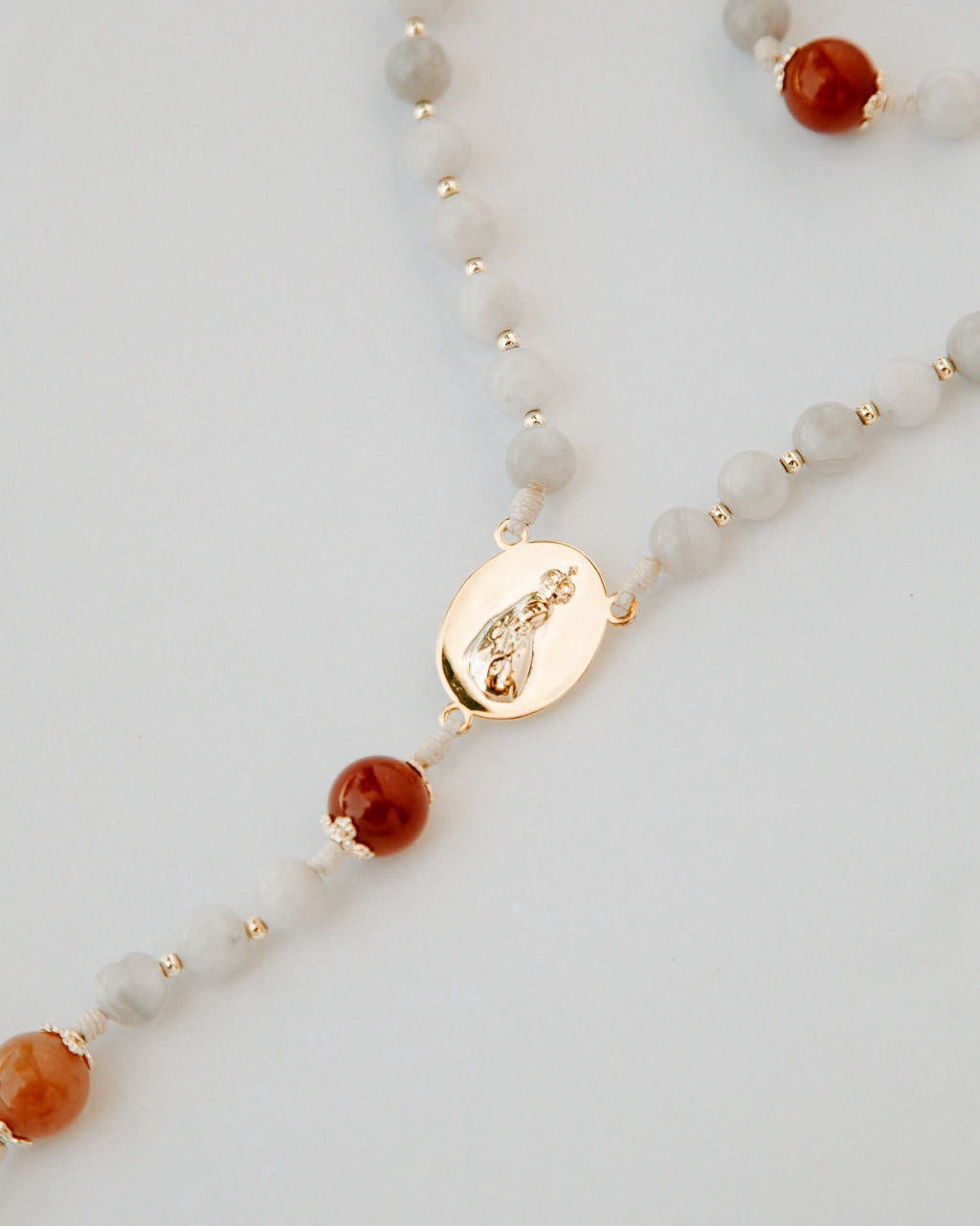 Rosary with white and orange beads with gold medal