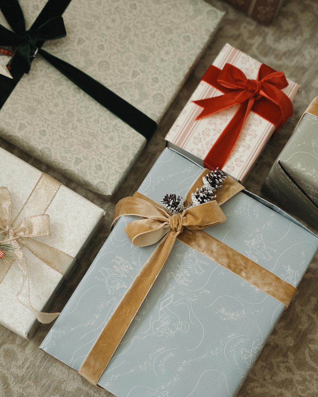 Gift boxes with decorative ribbons on a textured surface