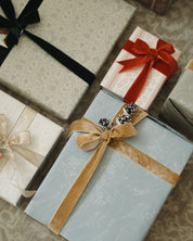 Gift boxes with decorative ribbons on a textured surface