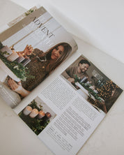 Open magazine with Christmas-themed content on a white surface