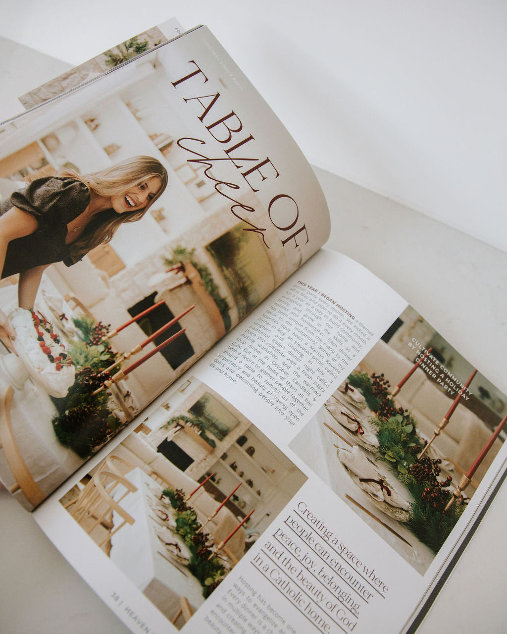 Open magazine with a focus on interior design, featuring images of a woman and a room.