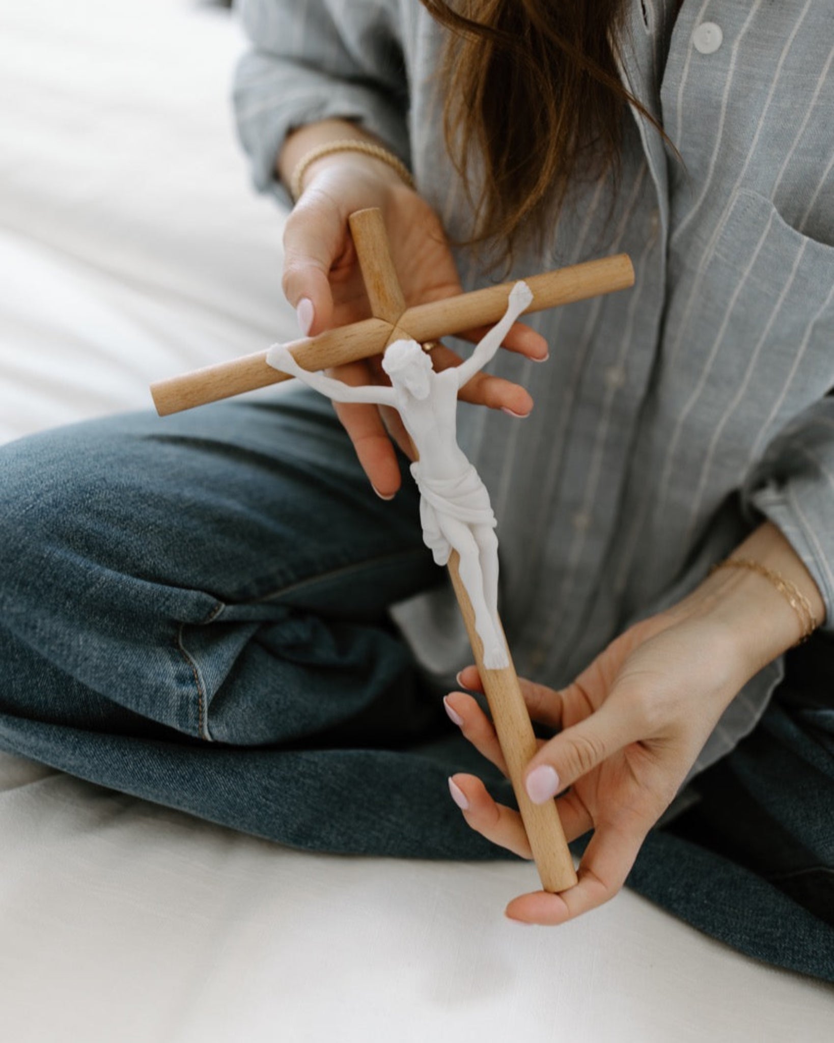 Modern wall crucifix held in woman's hands