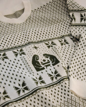 Close-up of a sweater with black geometric patterns on a white background