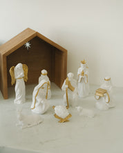 Nativity scene with figures and a stable on a white background