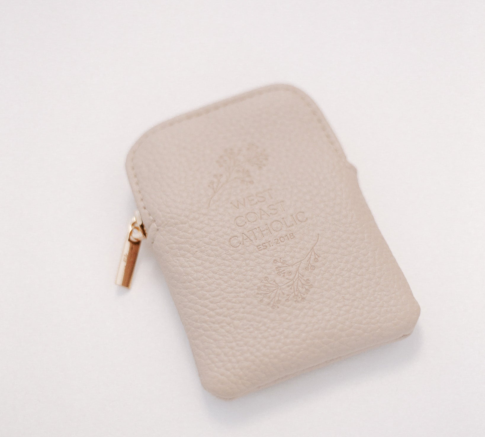 Beige leather rosary pouch with embossed logo on a white background