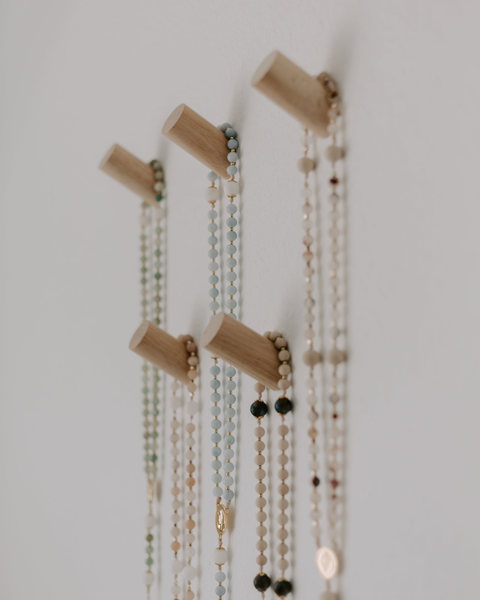 Rosary Pegs displayed on a wall with rosaries 