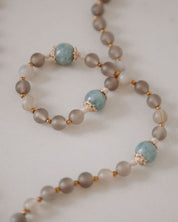 Brown and blue beads with gold accents on a white background