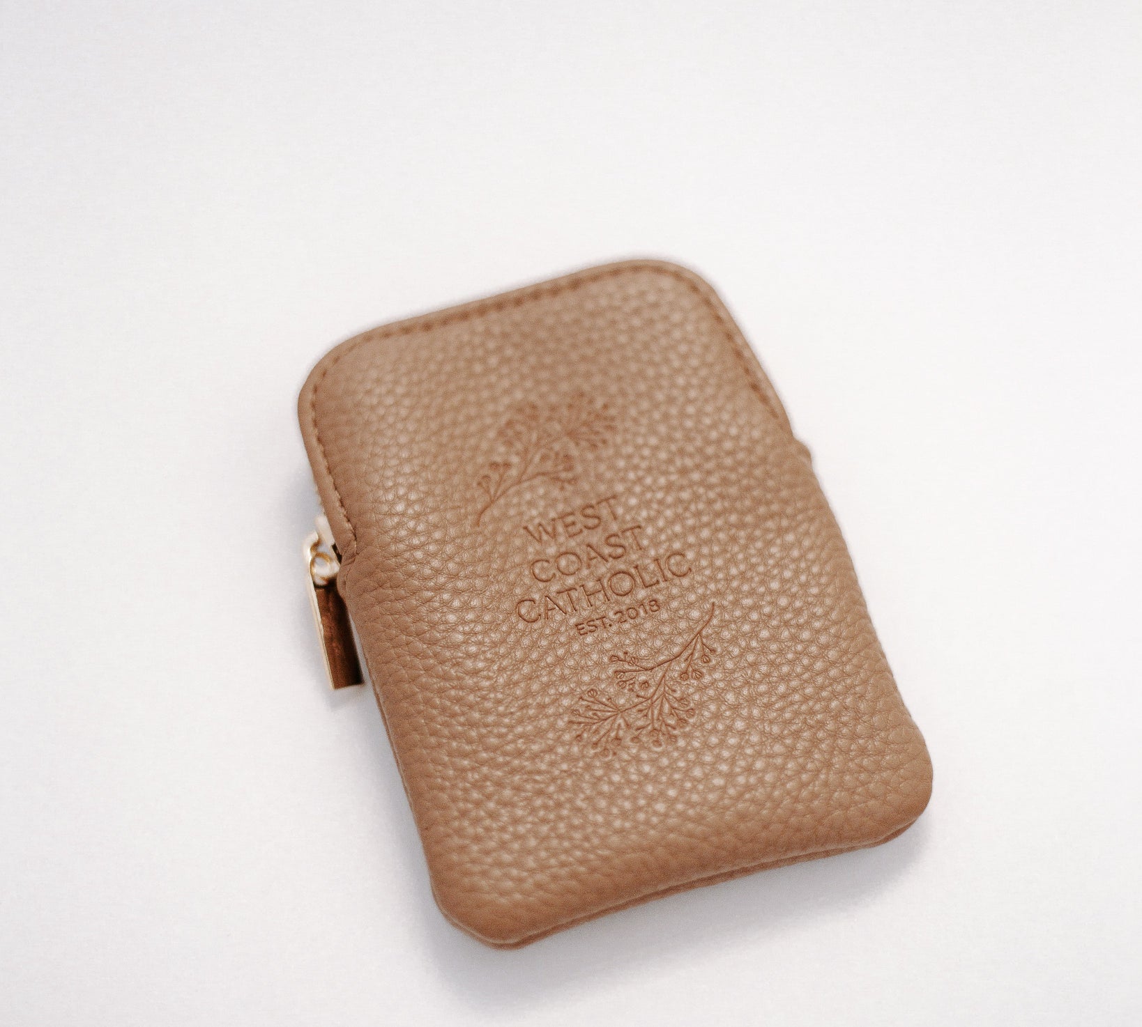 Brown leather rosary pouch with embossed logo on a white background