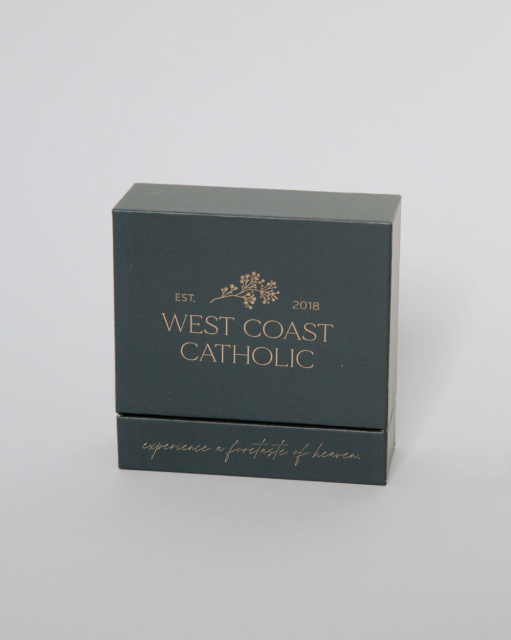 Dark gray box with 'West Coast Catholic' branding on a light gray background