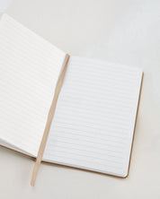 Open notebook with lined pages on a light gray background