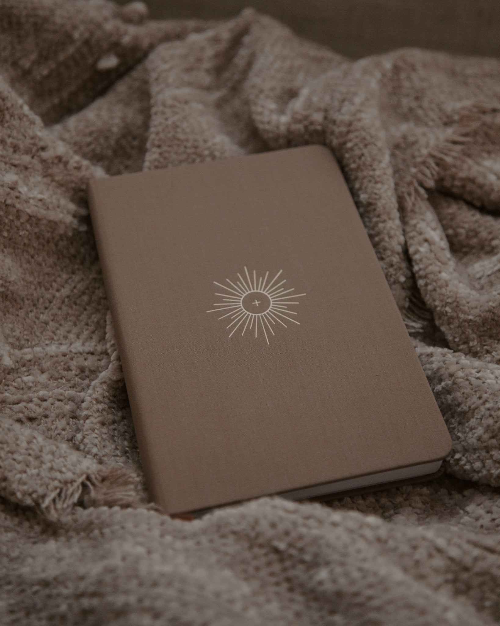 Brown linen journal on textured brown blanket