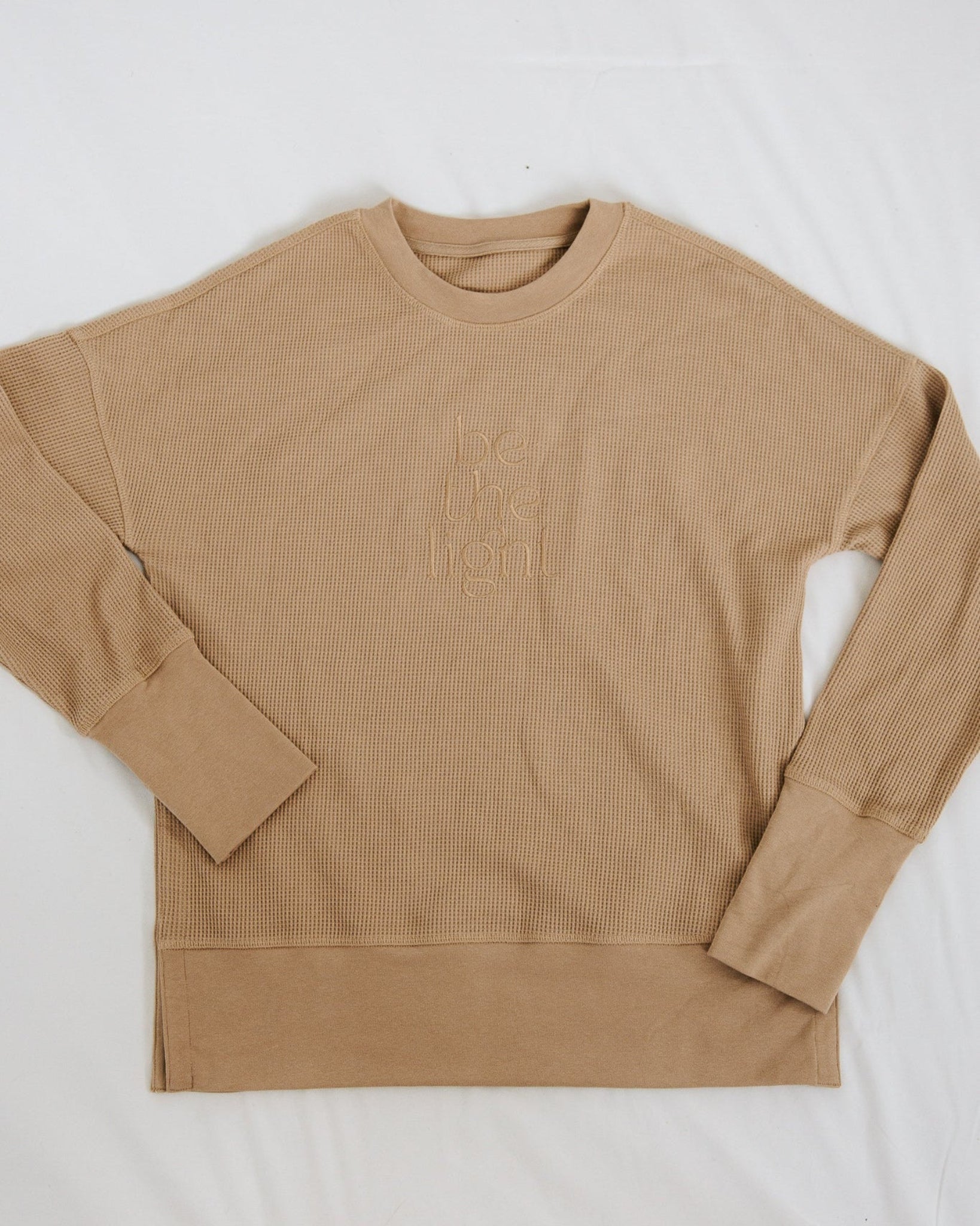 Beige long-sleeve shirt on a white background