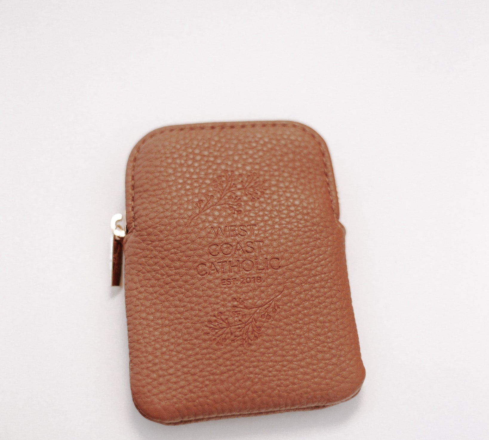 Brown leather rosary pouch with embossed logo on a white background