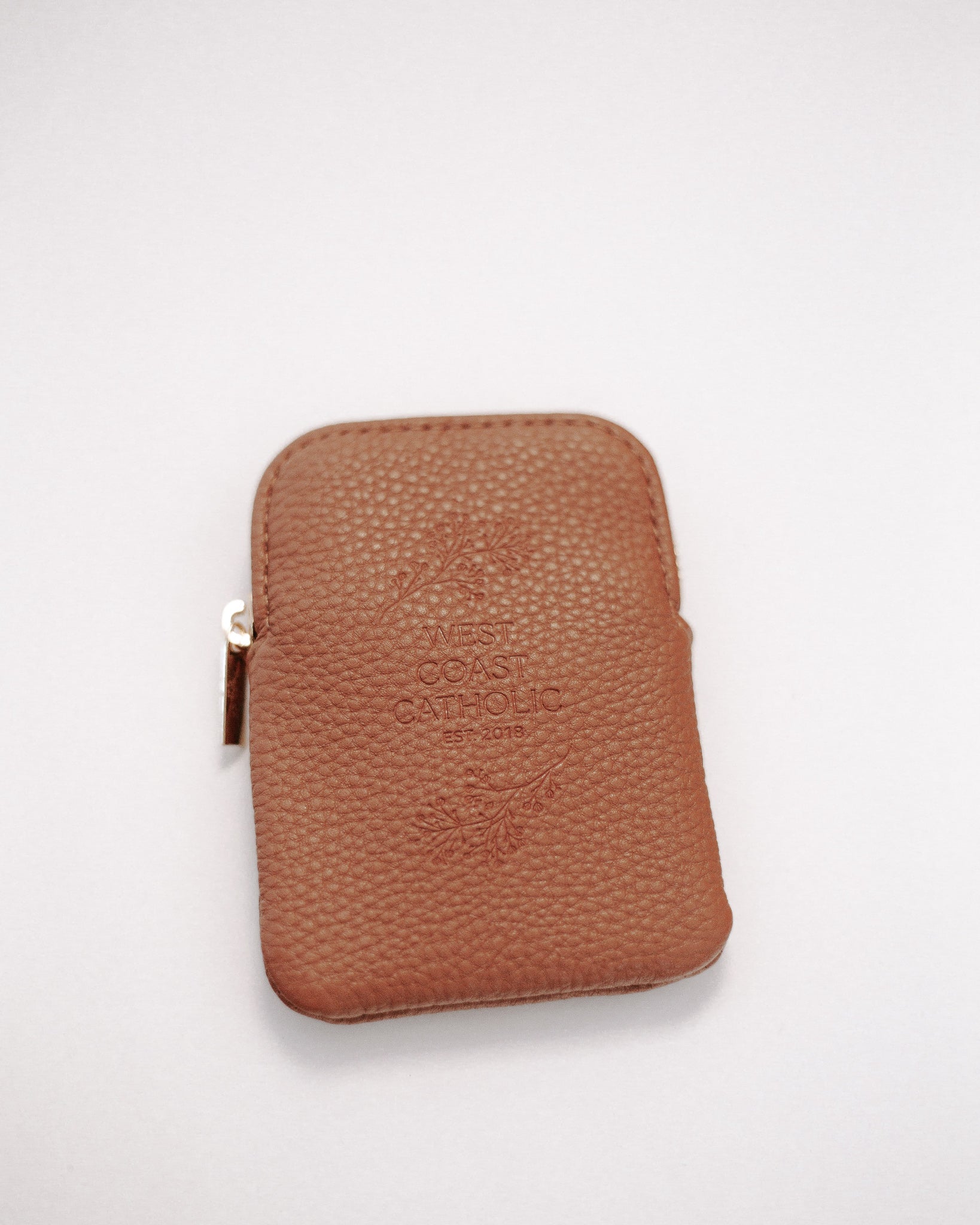Brown leather rosary pouch with embossed logo on a white background