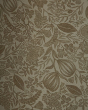 A close-up of a botanical patterned wallpaper or fabric featuring brown floral and leaf motifs on a warm beige background.