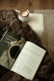 Heaven & Home Catholic magazine open to the Weekend Digital Detox Guide, styled with a cozy brown blanket and a latte for a peaceful fall Sunday routine.