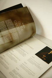 Heaven & Home magazine open to the, On the Calendar, liturgical living calendar --fall edition, featuring September, October, and November Catholic feast days on a marble counter top.