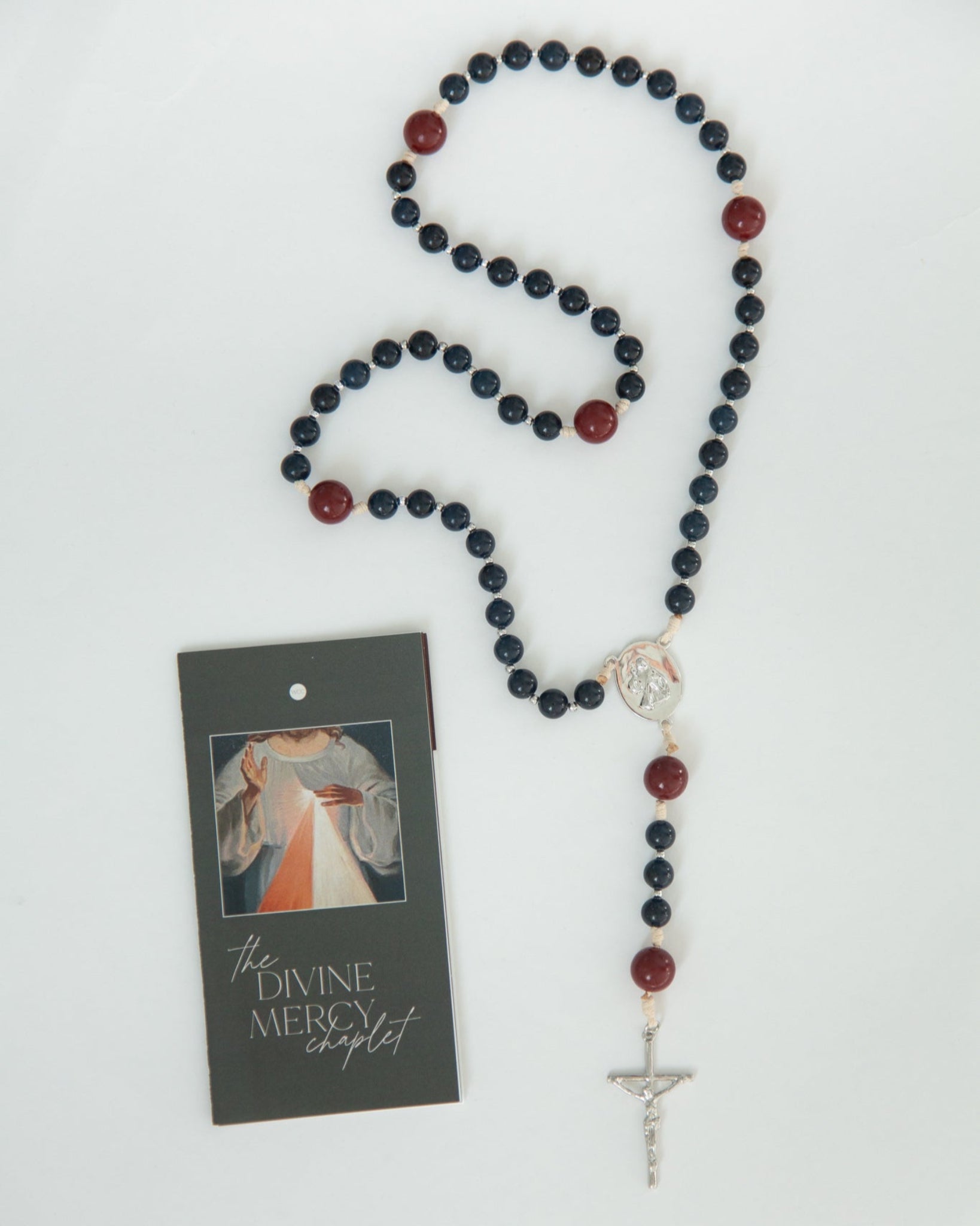 Rosary with blue and red beads on a white background
