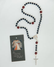 Rosary with blue and red beads on a white background