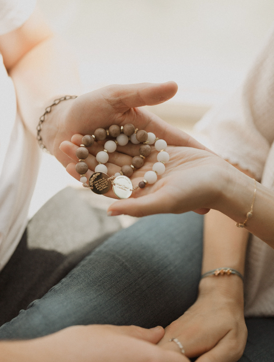 Couple hands holding the eden set rosary