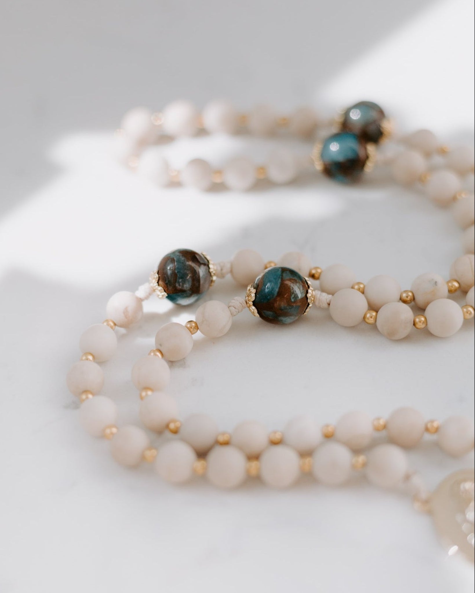 Set of beaded bracelets with gold accents on a white surface