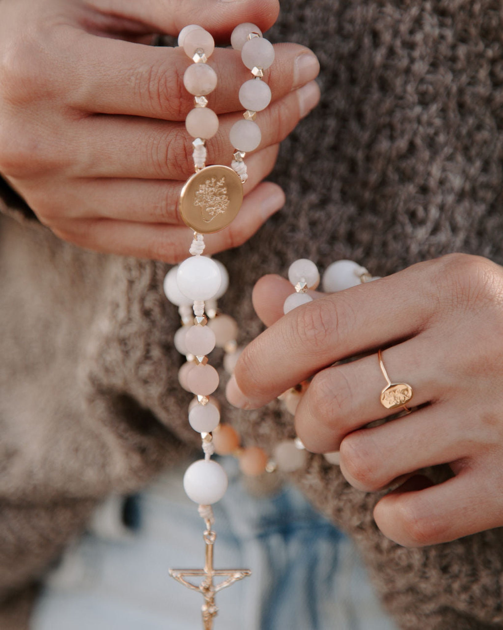 Hands praying with immaculate heart rosary
