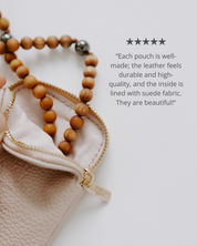 Leather pouch with wooden beads on a white background
