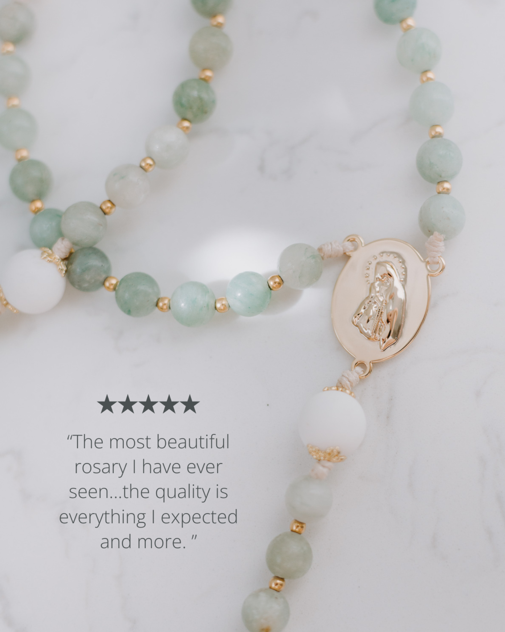Green beaded rosary with a gold medal on a white background
