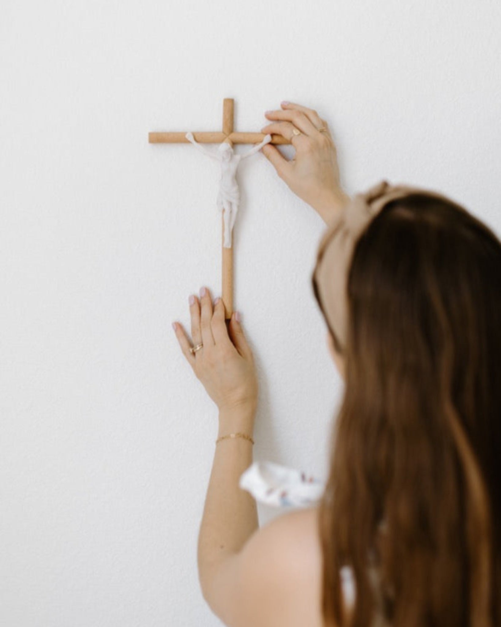 Modern wall crucifix hung on white wall