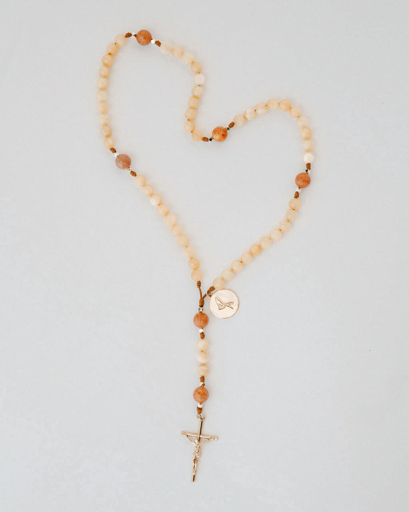 Beaded rosary with cream and orange beads and gold medal and cross details